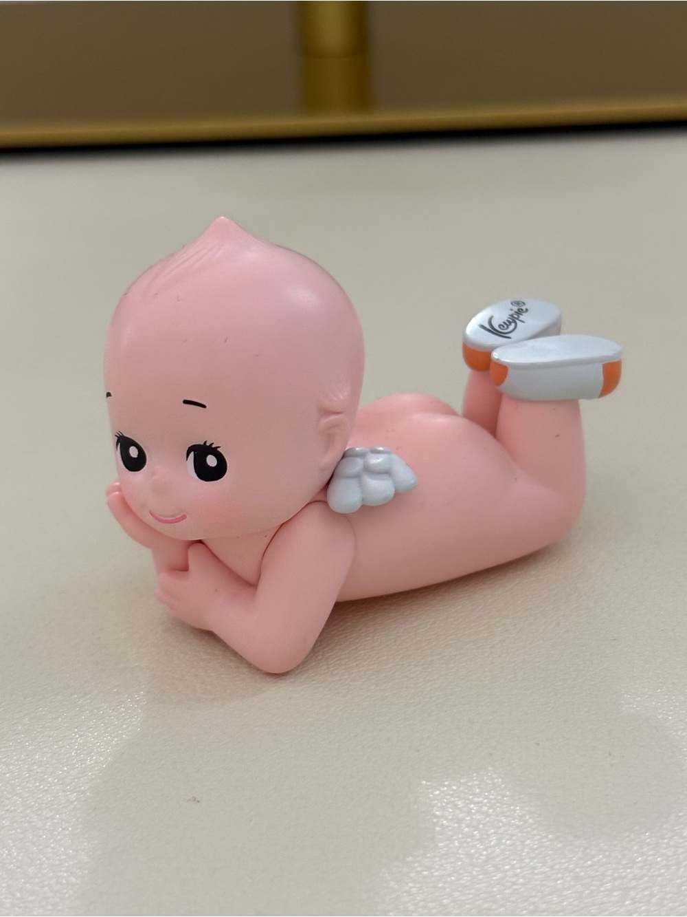 Kewpie laying down doll
